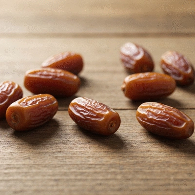 Close-up of fresh dates on a rustic wooden surface with a soft, natural light, no text, no words, no typography, clean image