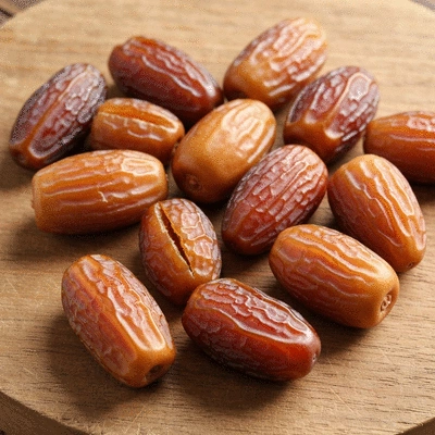 Assortment of fresh dates on a rustic wooden board