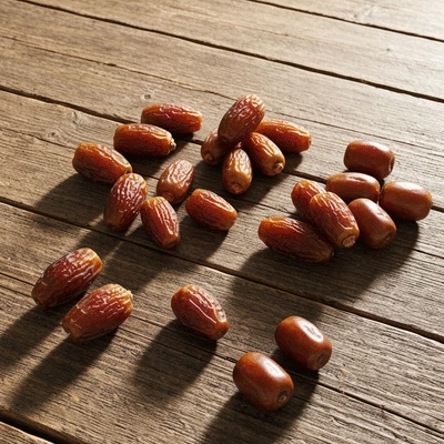 Assortment of different date varieties on a rustic wooden table, with some whole and some pitted, clean image