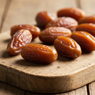 Close-up of fresh dates on a rustic wooden board with soft lighting, no text, no words, no typography, clean image