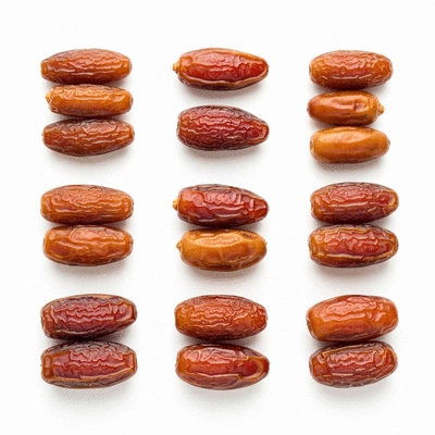 A display of various date varieties, some organic and some conventional, showcasing their differences in texture and color